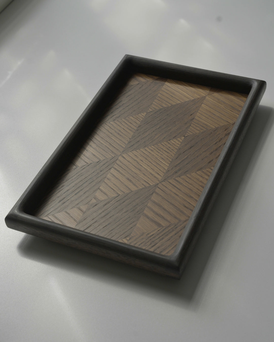 Skimmer Parquet Tray in fumed oak, with rounded edges and a hand-laid oak veneer parquet pattern