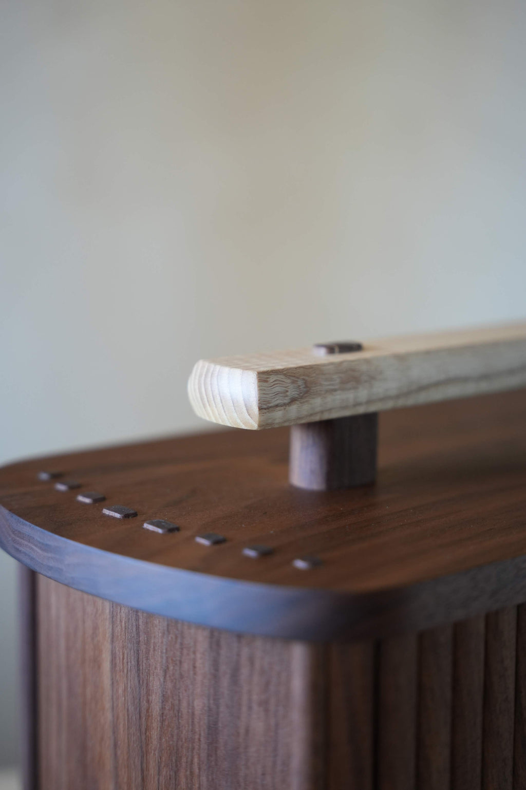 Close up of a wooden box with a handle on a blurred background