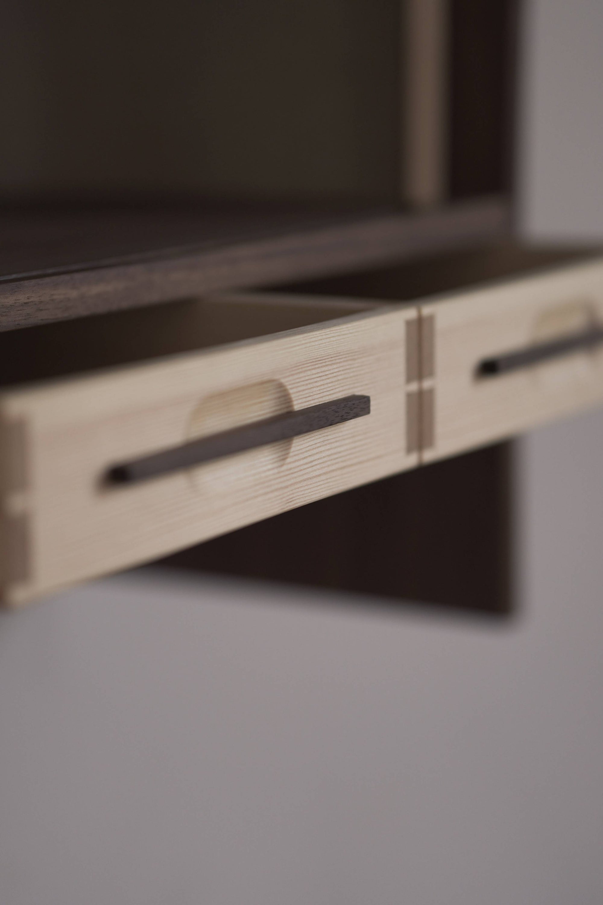 Close-up of a wooden cabinet with drawers on a blurred background