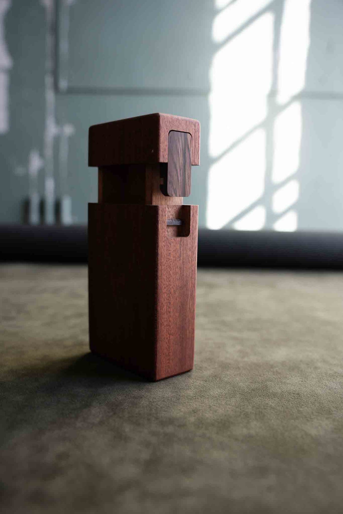 Handcrafted wooden object from od form featuring architectural design and minimalist joinery details.