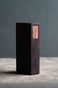 Closed fumed oak box standing upright, with a light apple wood latch contrasting against the dark oak