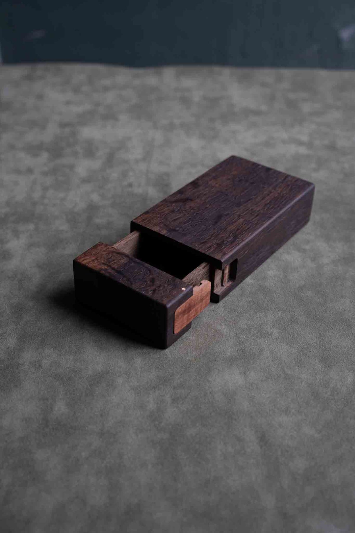 Small fumed oak box slid partly open, showing the apple wood latch on the end
