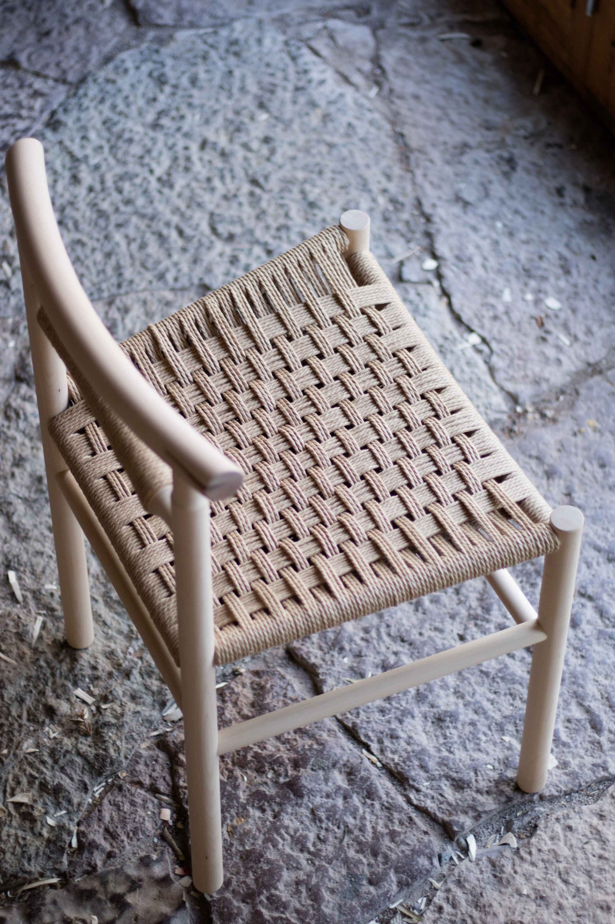Woven chair on a stone floor