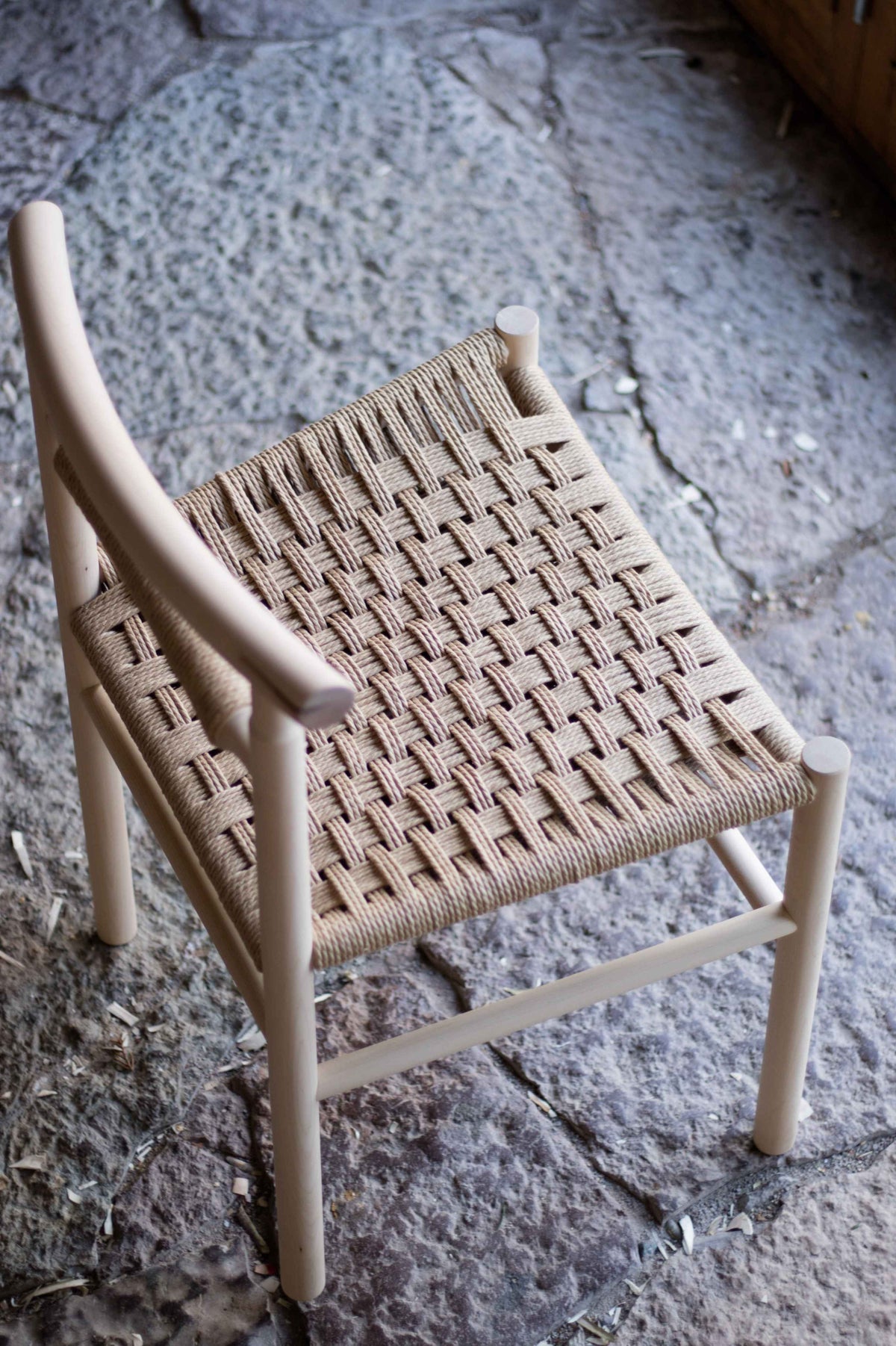 Woven chair on a stone floor