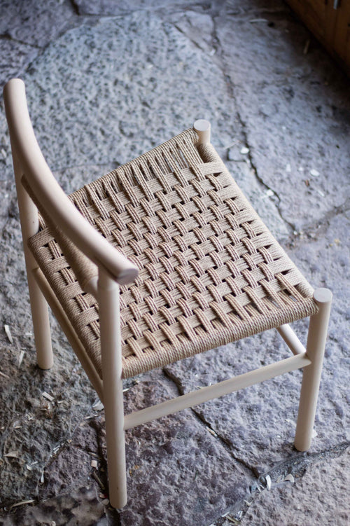 Woven chair on a stone floor